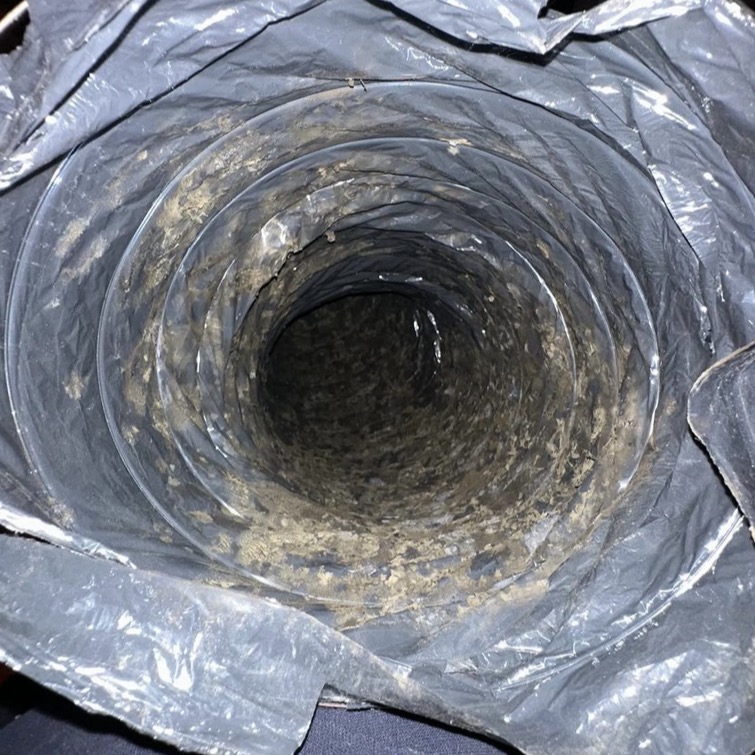 Dust buildup inside an air duct before cleaning