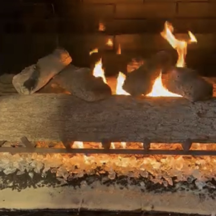 Gas fireplace flame with ceramic logs